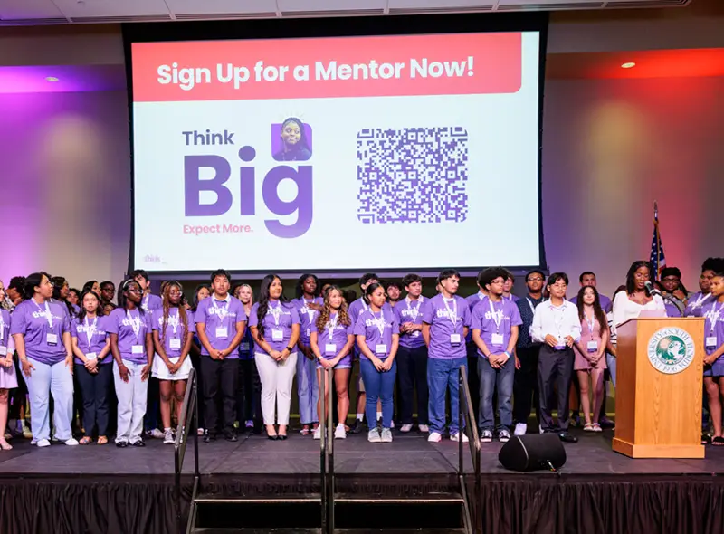 Group of people standing on stage at Think Big for Kids event.